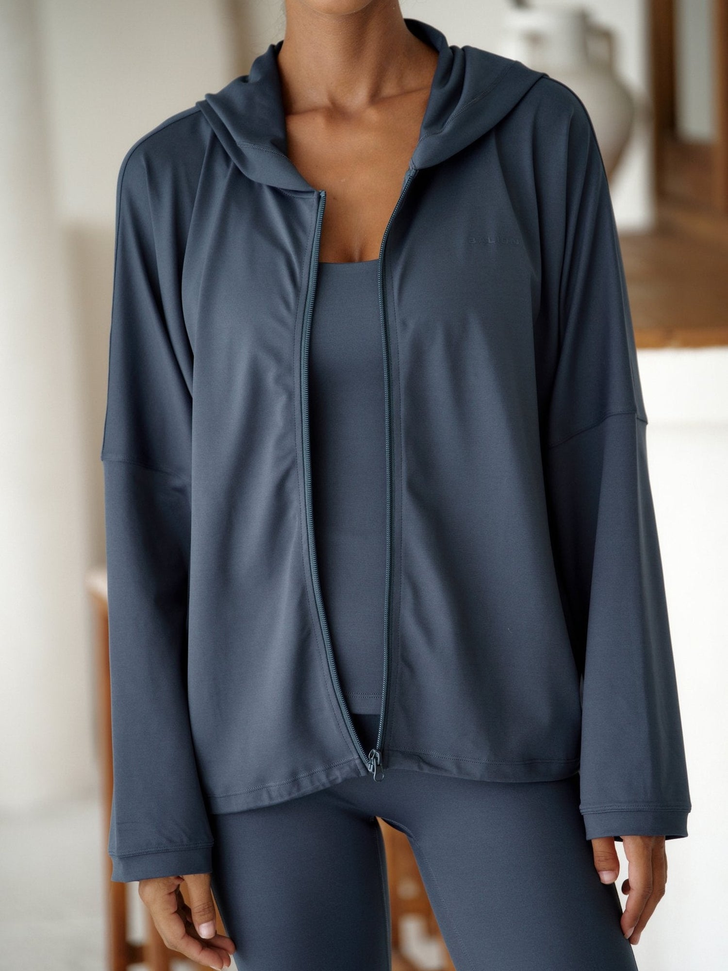 Ekstremt nærbilde av Balion-logo på Studio Flow Jacket Lunar Grey – stofftekstur og glidelåsdetalj